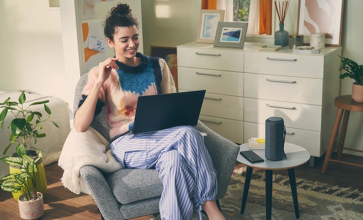 Image of a person with their laptop and the SRS-XE200 X-Series Portable Wireless Speaker