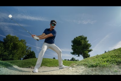 Example image of a male golfer swinging a club to take a shot