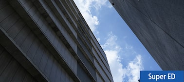 Example image showing sky and clouds framed between two tall, dark buildings